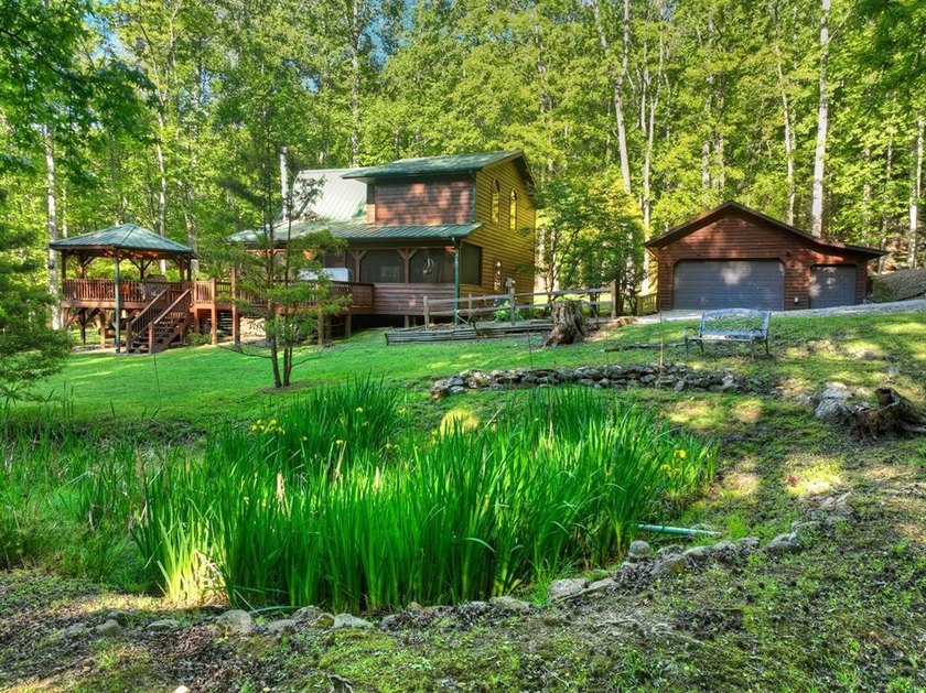 Tucked beneath a canopy of towering hardwoods and surrounded by - photo 2