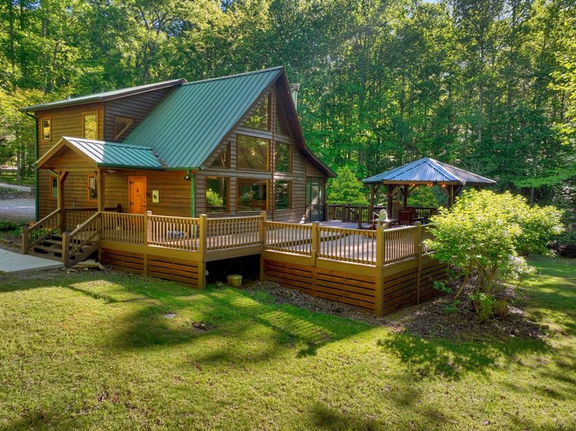 Tucked beneath a canopy of towering hardwoods and surrounded by - photo 3