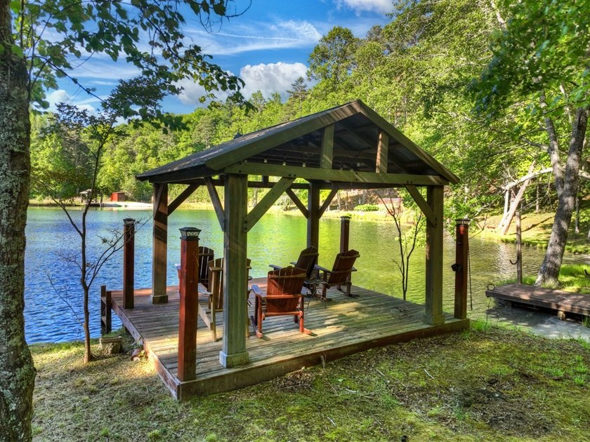 Tucked beneath a canopy of towering hardwoods and surrounded by - photo 5