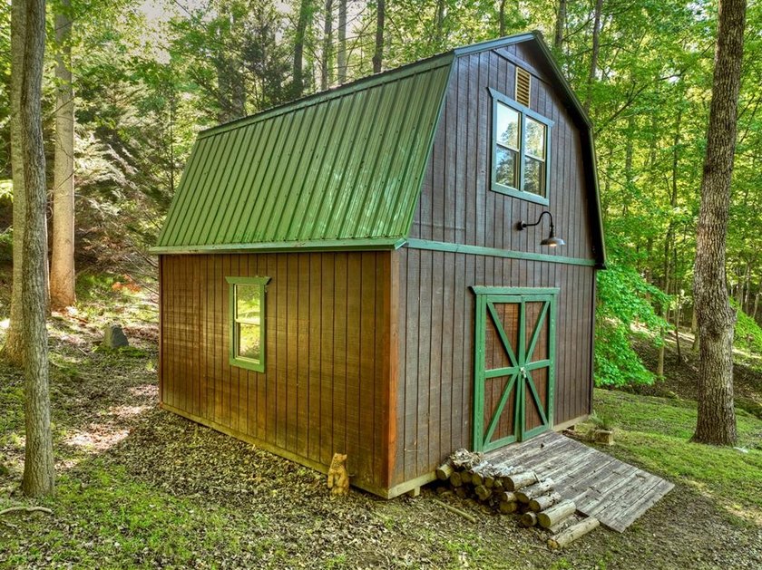 Tucked beneath a canopy of towering hardwoods and surrounded by - photo 9