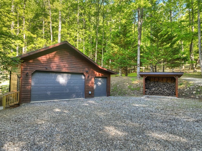 Tucked beneath a canopy of towering hardwoods and surrounded by - photo 10