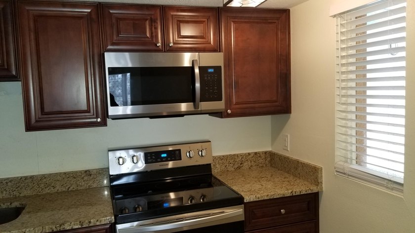 This updated ground floor unit features closed in porch; - photo 2