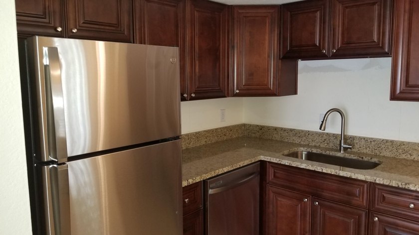 This updated ground floor unit features closed in porch; - photo 3