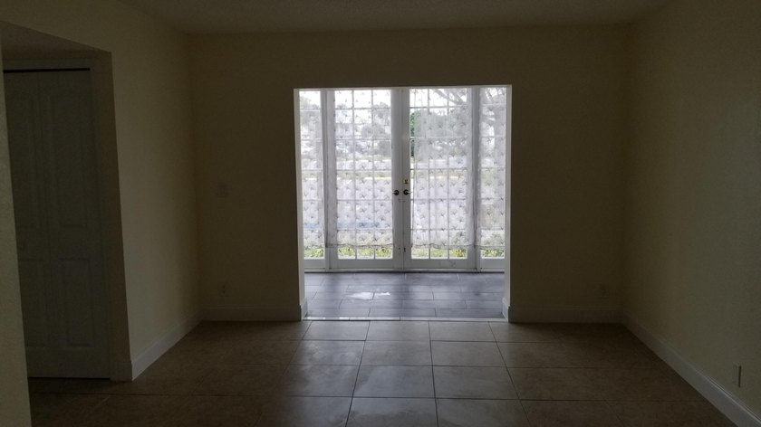 This updated ground floor unit features closed in porch; - photo 5