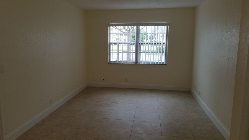 This updated ground floor unit features closed in porch; - photo 7