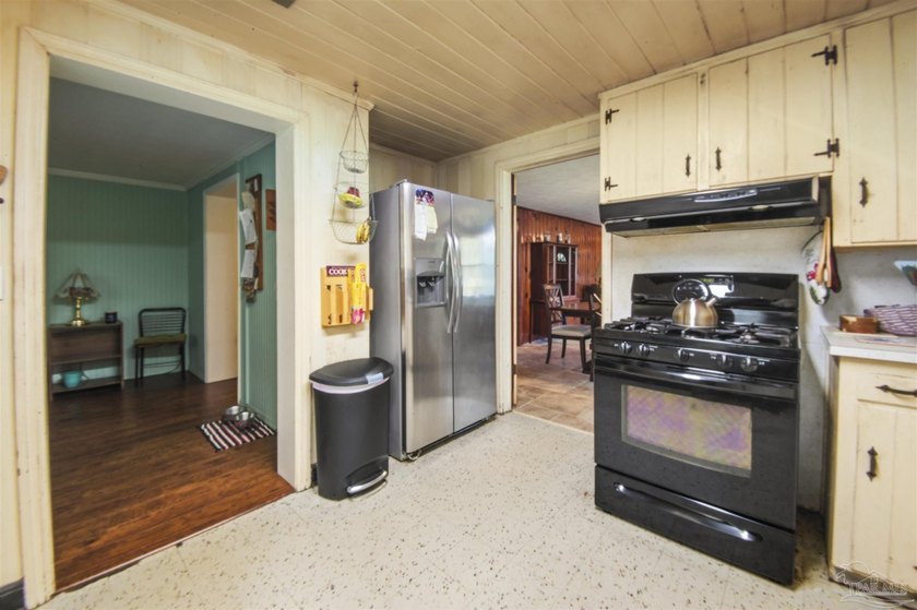 This spacious POOL home is positioned on NEARLY AN ACRE in the - photo 11