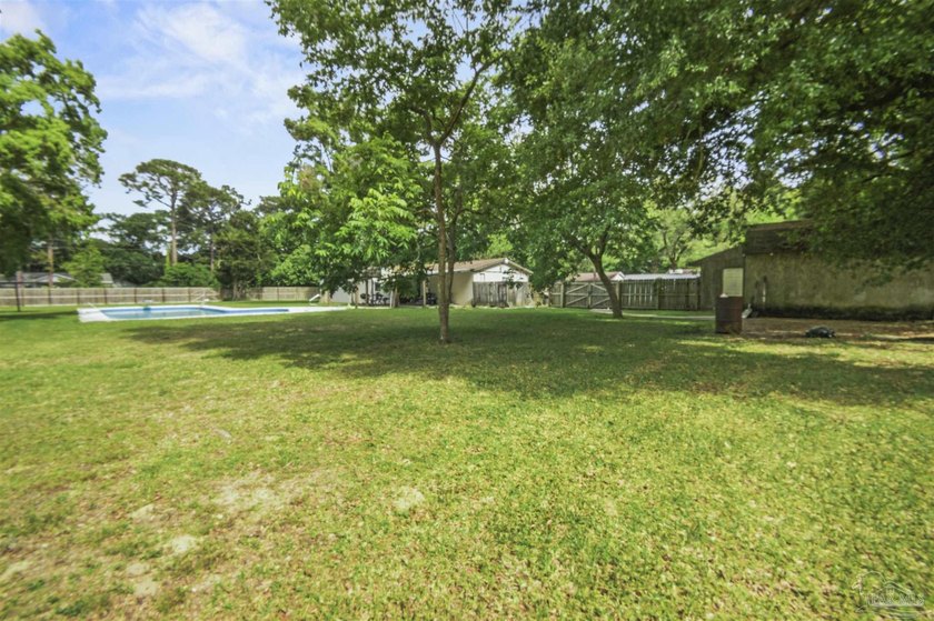 This spacious POOL home is positioned on NEARLY AN ACRE in the - photo 19