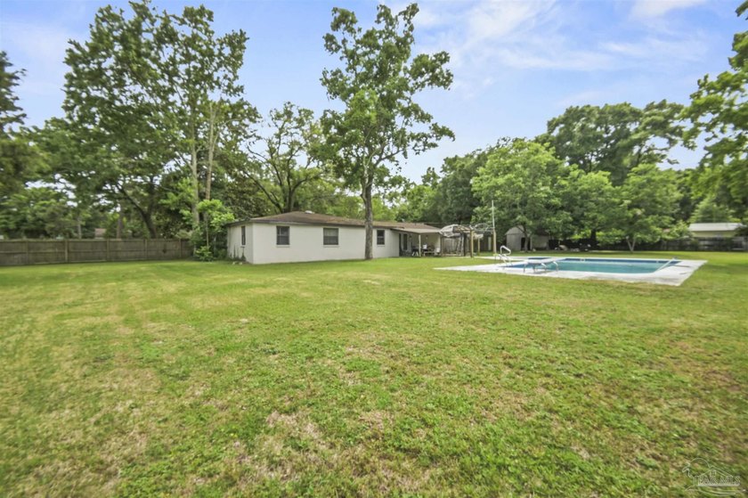 This spacious POOL home is positioned on NEARLY AN ACRE in the - photo 20