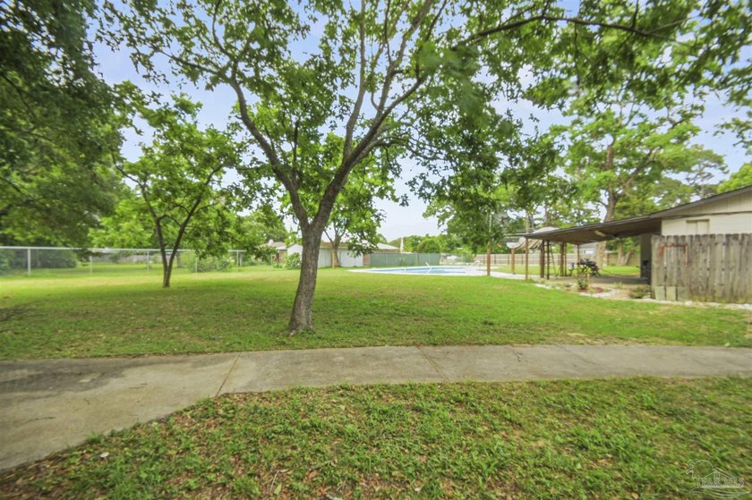 This spacious POOL home is positioned on NEARLY AN ACRE in the - photo 22