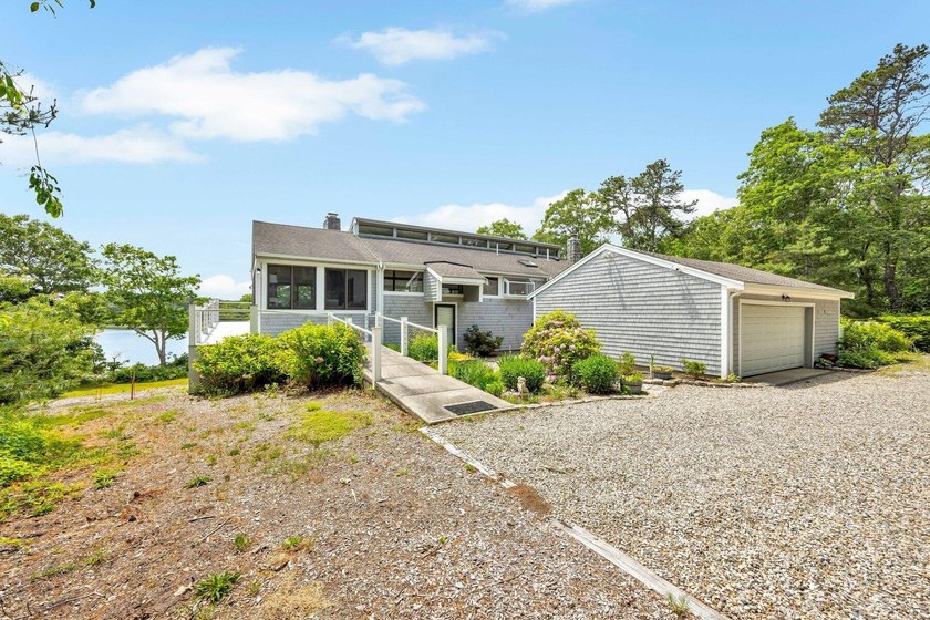 Set on over 3 private acres along the protected shores of - photo 11