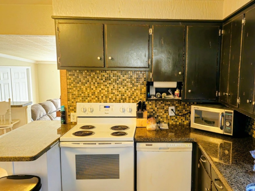 Take a look at this inviting 4-bedroom, 2-bathroom home tucked - photo 7