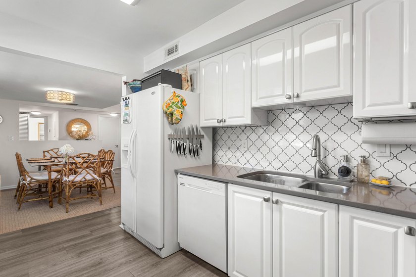 Positioned mere steps from the shoreline, this three-bedroom - photo 13
