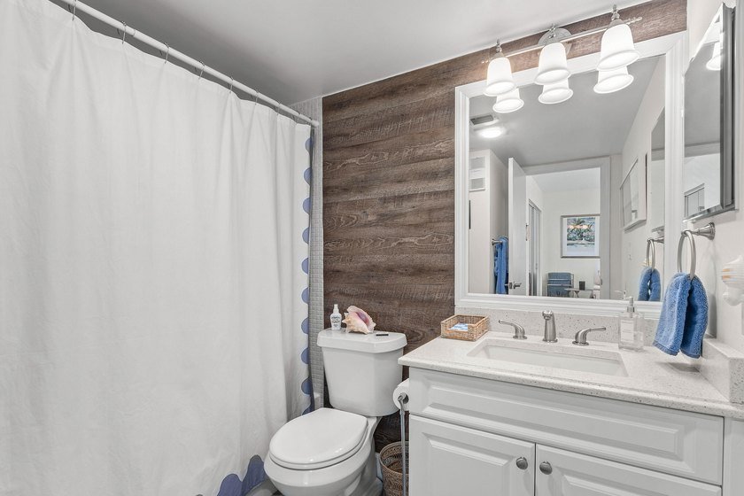 Positioned mere steps from the shoreline, this three-bedroom - photo 23