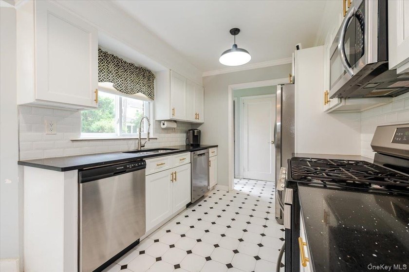 Welcome to this sunlit all brick center hall colonial located in - photo 11