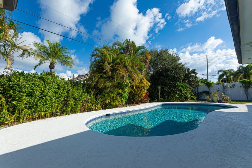 Tucked away on an oversized corner lot in the sought-after - photo 25