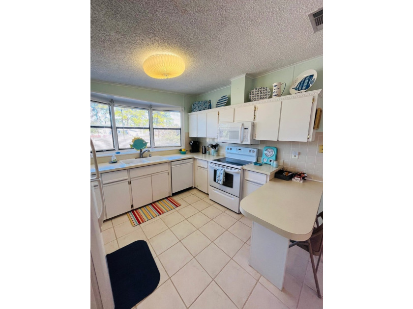 This meticulously maintained two-bedroom, two-bath home is - photo 3