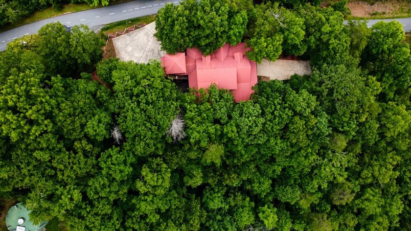 Tucked into a private wooded setting on top of the mountain in - photo 5