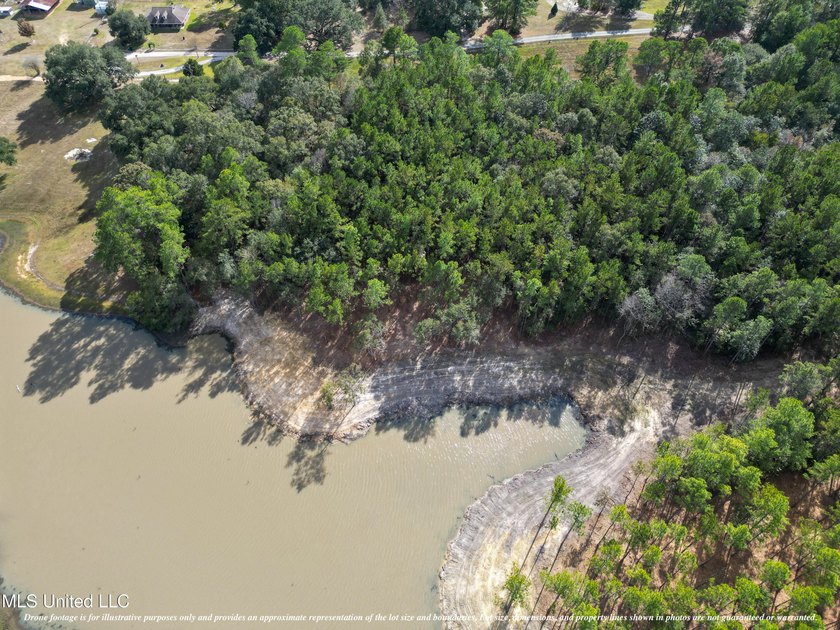 Nestled on 7.57 acres of wooded land overlooking a lake, this - photo 2