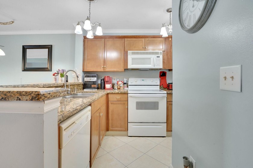 Welcome to this inviting first-floor condo in a gated community - photo 3