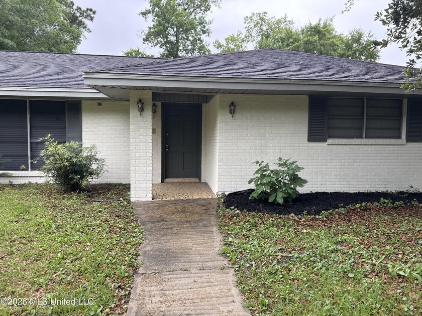 This well-maintained 4-bedroom, 2-bath brick home is situated on - photo 2