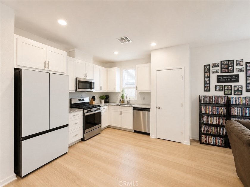 PRICE TO SELL WITH TONS OF UPGRADES! Experience modern living in - photo 2