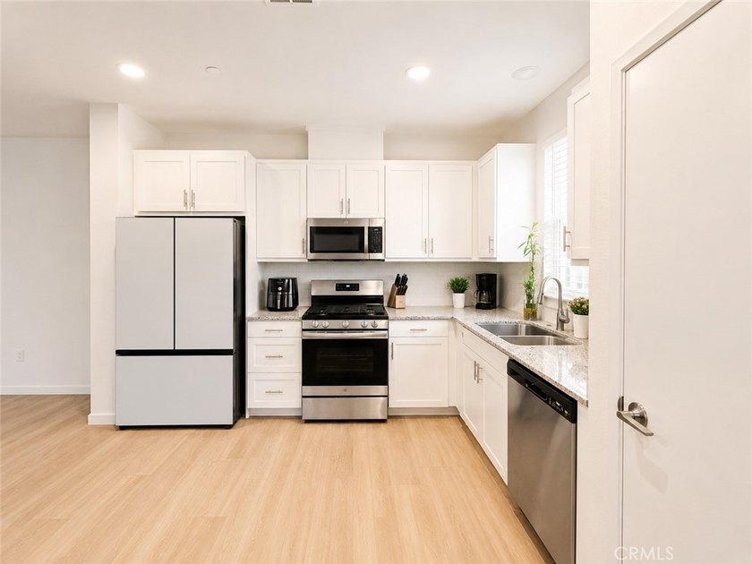 PRICE TO SELL WITH TONS OF UPGRADES! Experience modern living in - photo 3
