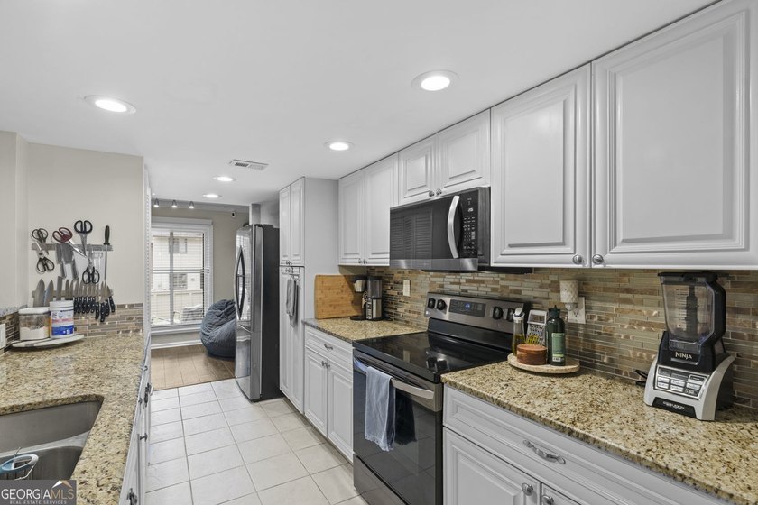 Welcome to this inviting end-unit townhome nestled in the highly - photo 20
