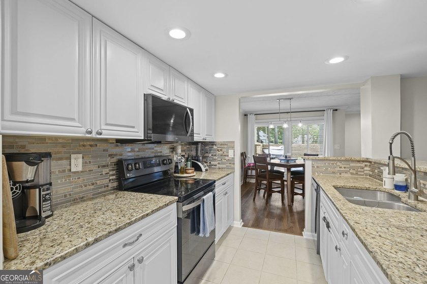 Welcome to this inviting end-unit townhome nestled in the highly - photo 23