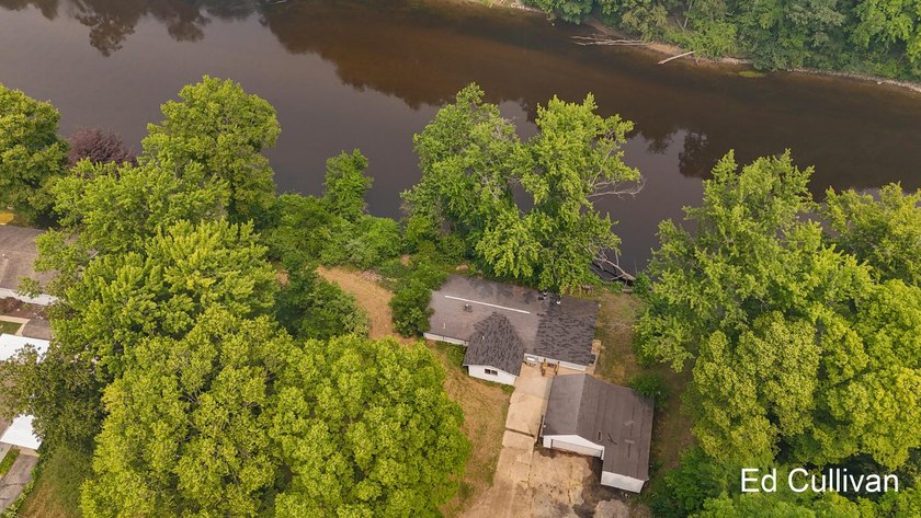 Enjoy the best of Muskegon River living with this updated - photo 3