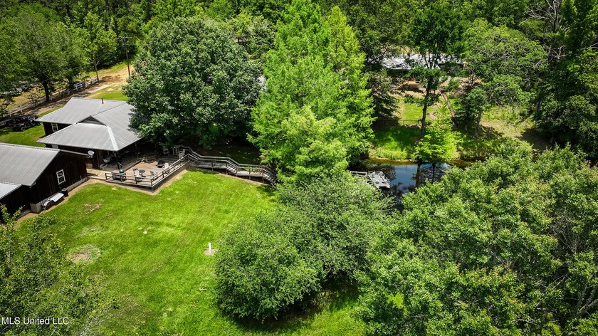 Hilltop Residence and new doublewide overlook a stocked lake and - photo 8