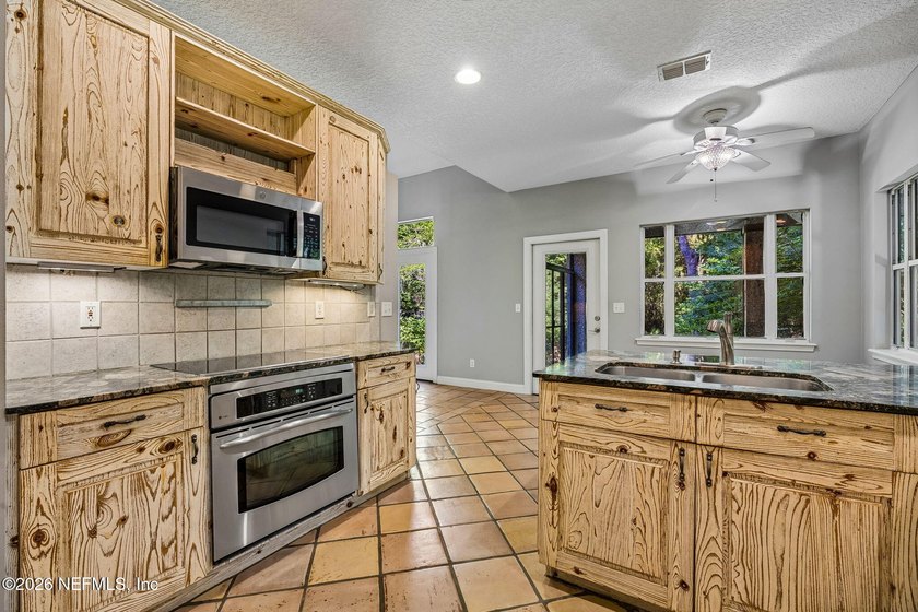 Nestled beneath a canopy of majestic live oaks and surrounded by - photo 25