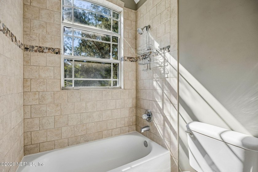 Nestled beneath a canopy of majestic live oaks and surrounded by - photo 35