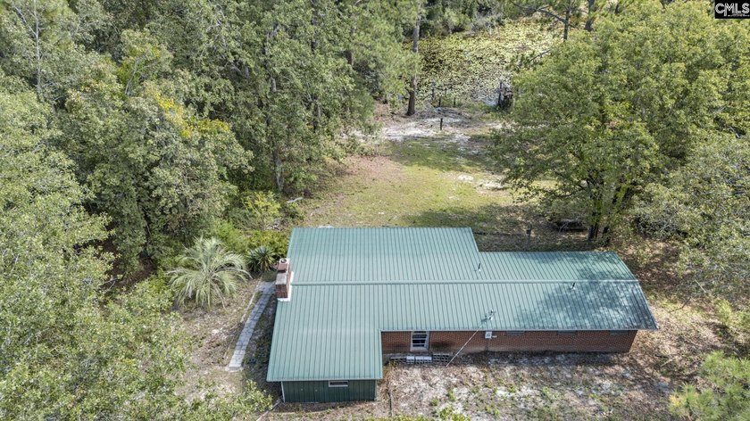 A long, private, tree-lined drive leads to a brick cabin - photo 10