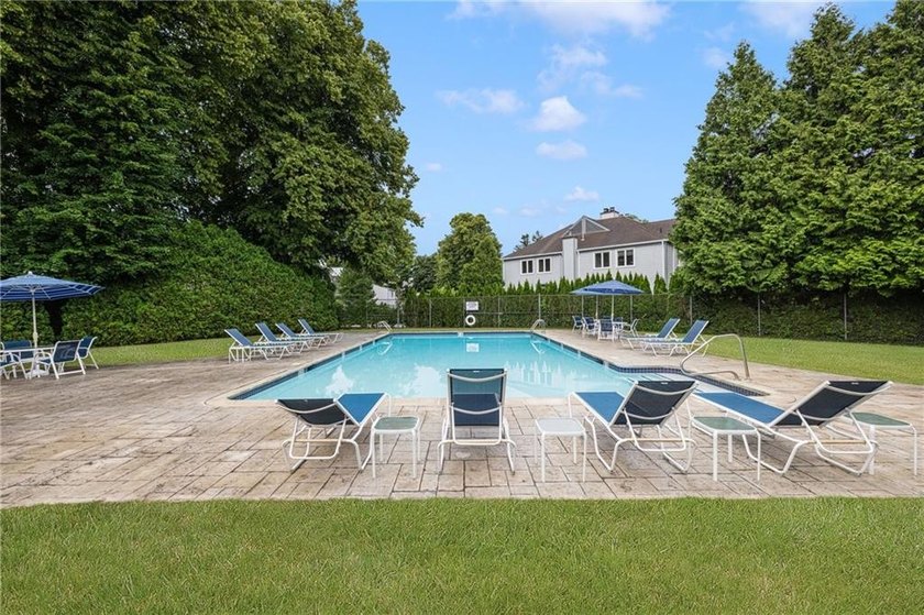 Overlooking the lush greenery and in-ground pool, this private - photo 22