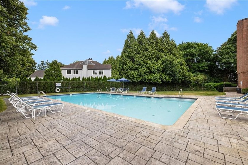 Overlooking the lush greenery and in-ground pool, this private - photo 23