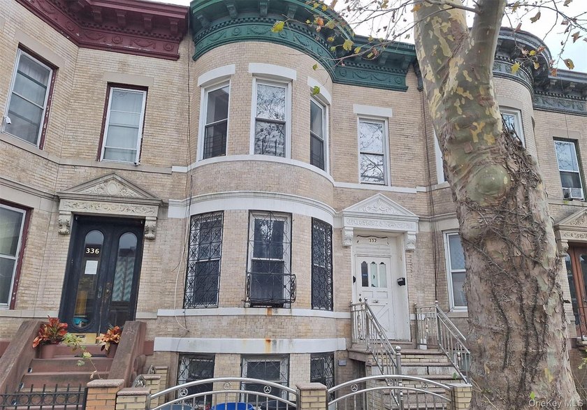 This two-family home features seven bedrooms and three full - photo 2
