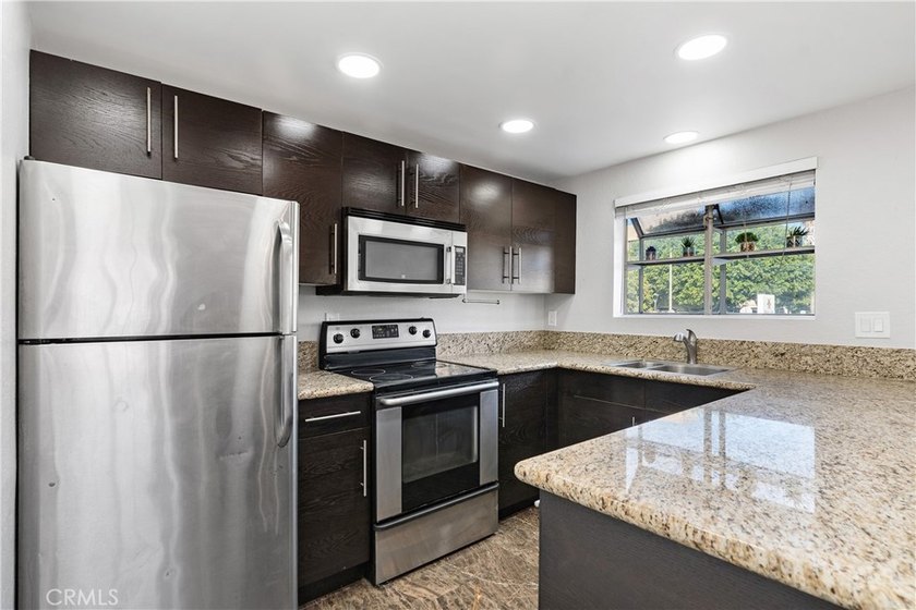 This two-story, townhouse-style condominium offers two primary - photo 12