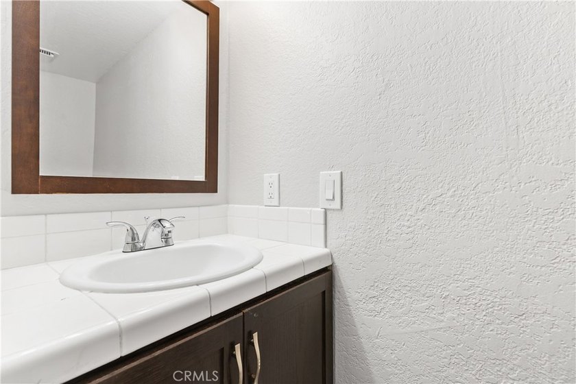 This two-story, townhouse-style condominium offers two primary - photo 17