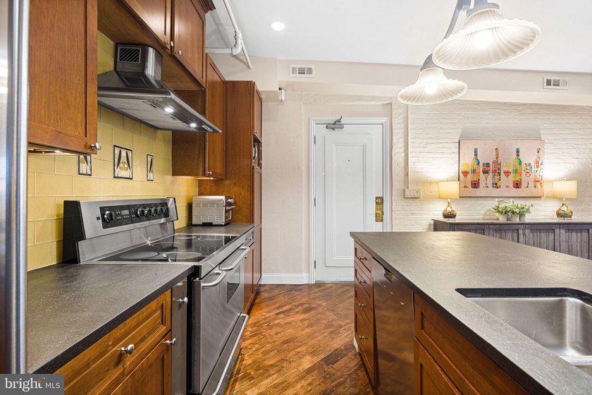 This beautifully updated penthouse offers a unique blend of - photo 5