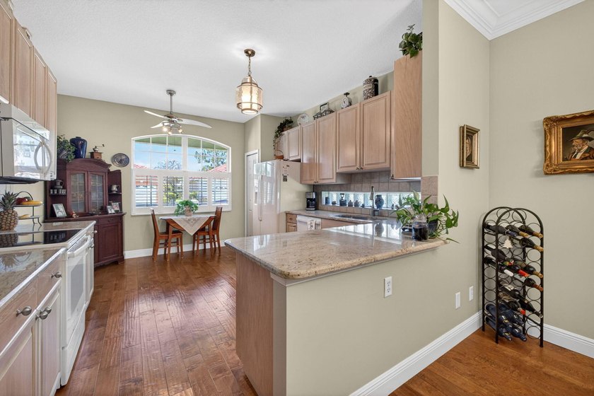 Situated on a large corner lot with lush tropical landscaping - photo 10