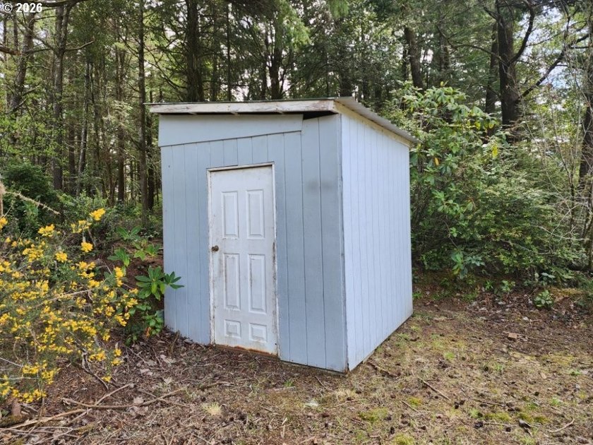 Tucked away among the trees on 1.16 private acres with a Large - photo 25