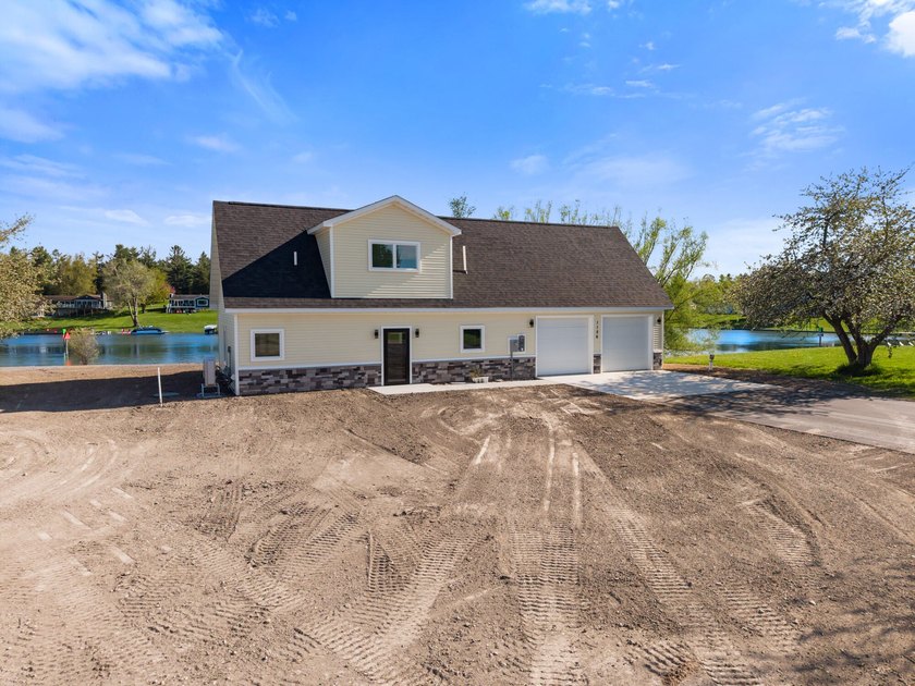 Brand new construction on the beautiful Cheboygan River! Enjoy - photo 2