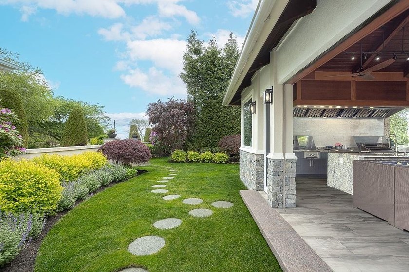 Set behind layers of mature landscaping and sculpted hedges - photo 15