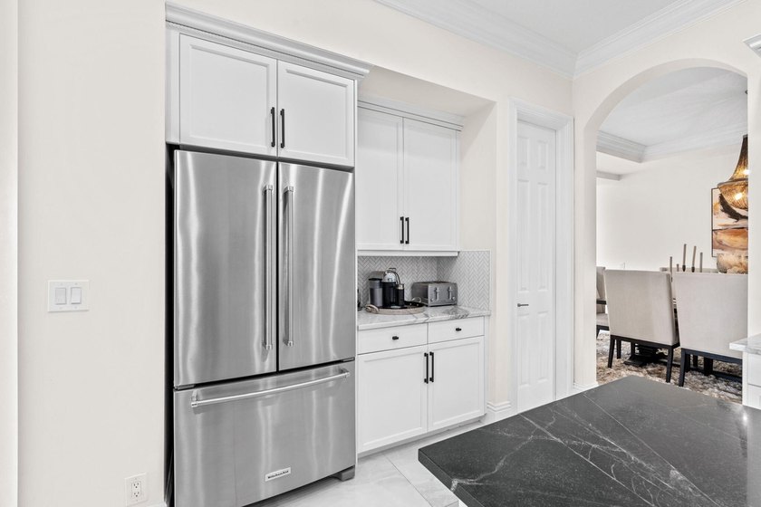 Beyond double entry doors, a remodeled iron staircase frames - photo 19