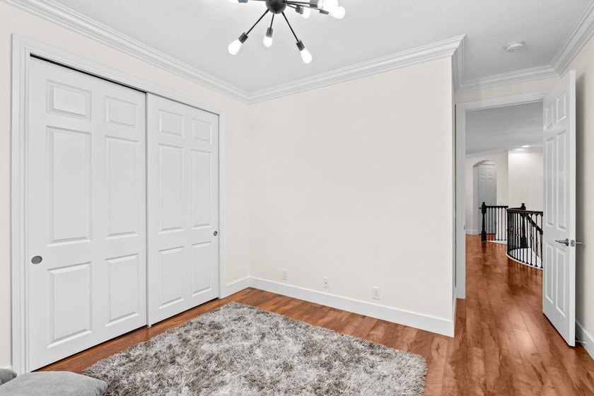 Beyond double entry doors, a remodeled iron staircase frames - photo 40