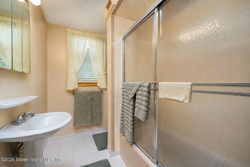 THIS TWO FAMILY HI-RANCH OFFERS A 3 BEDROOM MASTER PLUS A ONE - photo 13