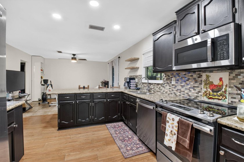 This charming home boasts hardwood floors throughout, granite - photo 12
