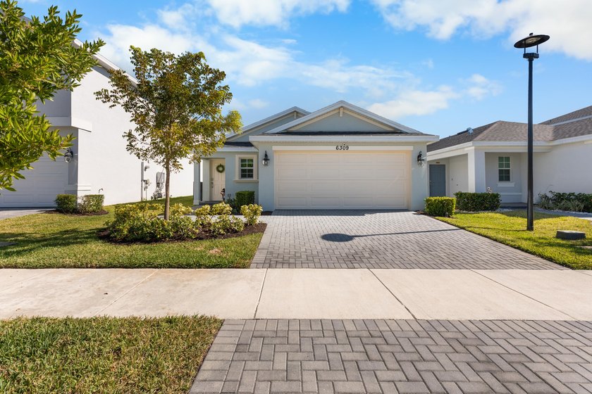 This new single-story home features a smart layout designed for - photo 6
