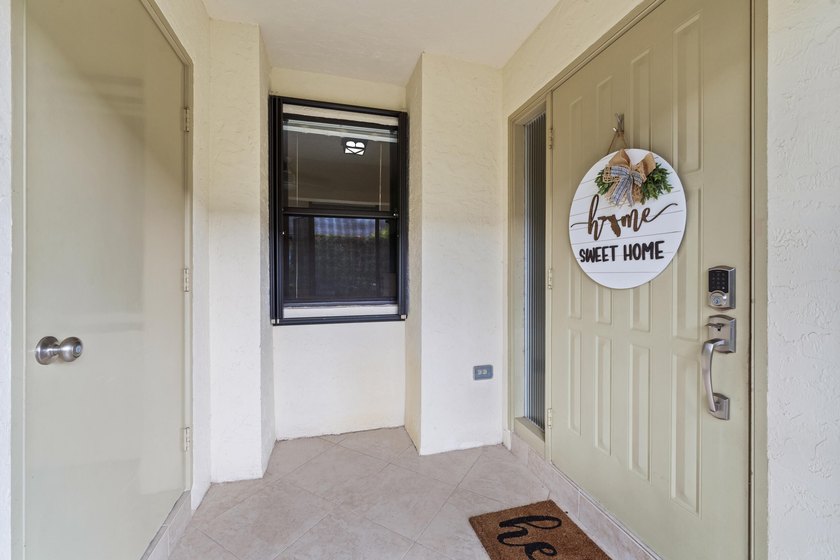 Welcome to this charming corner unit three-bedroom, two-bathroom - photo 10