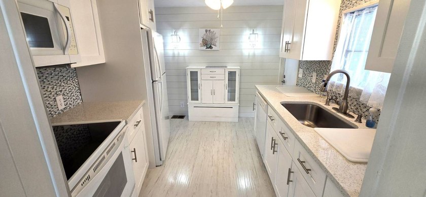 Discover carefree living in this meticulously renovated - photo 3